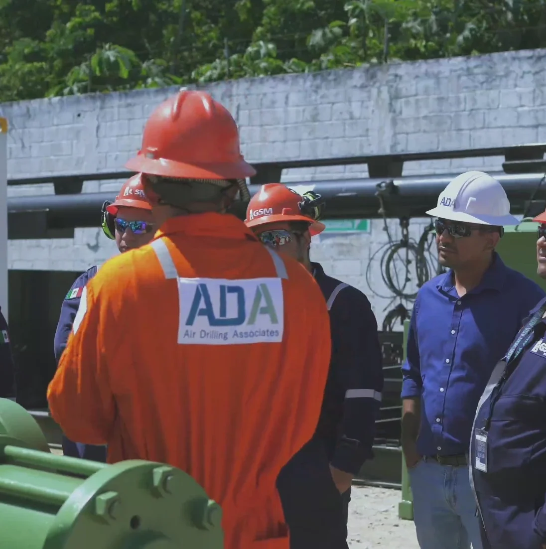A group of ADA workers huddled around in a meeting
