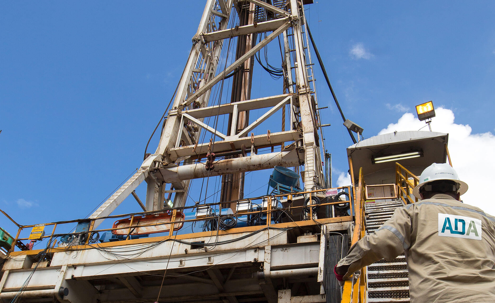 ADA worker climbing steps to rig